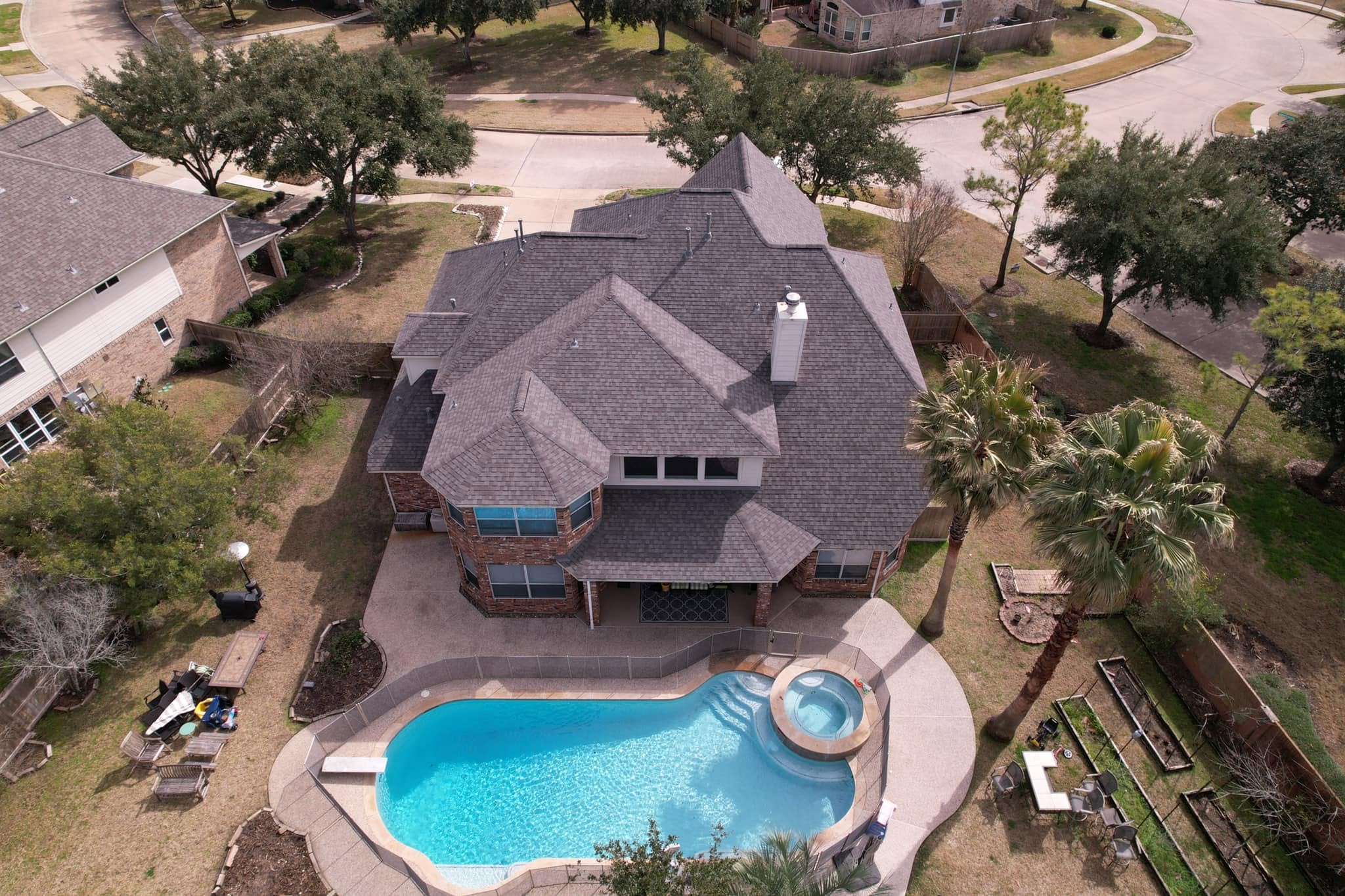 Drone inspecting roof damage in West Houston Energy Corridor home